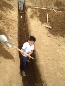 Manuel helping to build his school in 2013